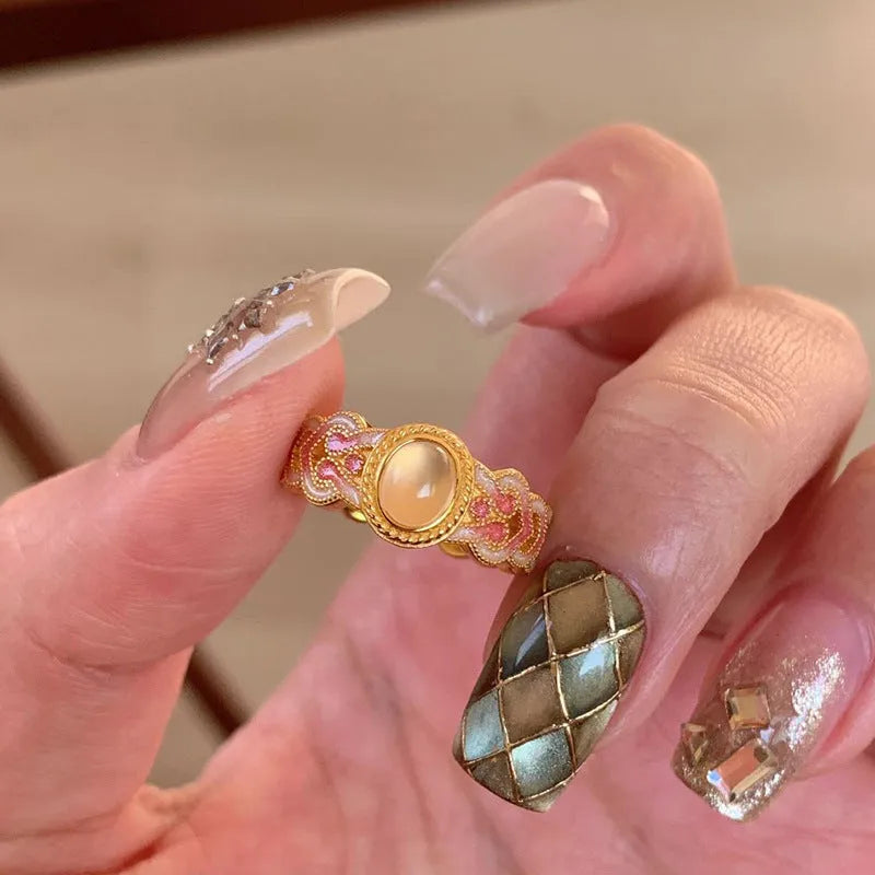 Pink crystal enamel ring with geometric design and adjustable open mouth on a copper base