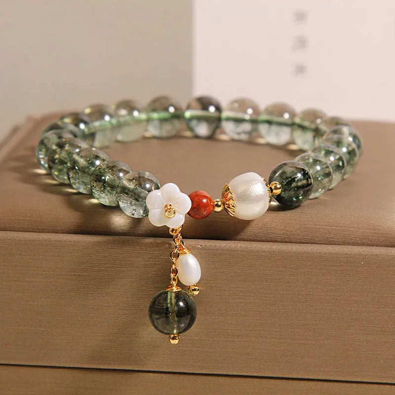 Green phantom quartz crystal bracelet with small bells of Ireland design and shell flower accents