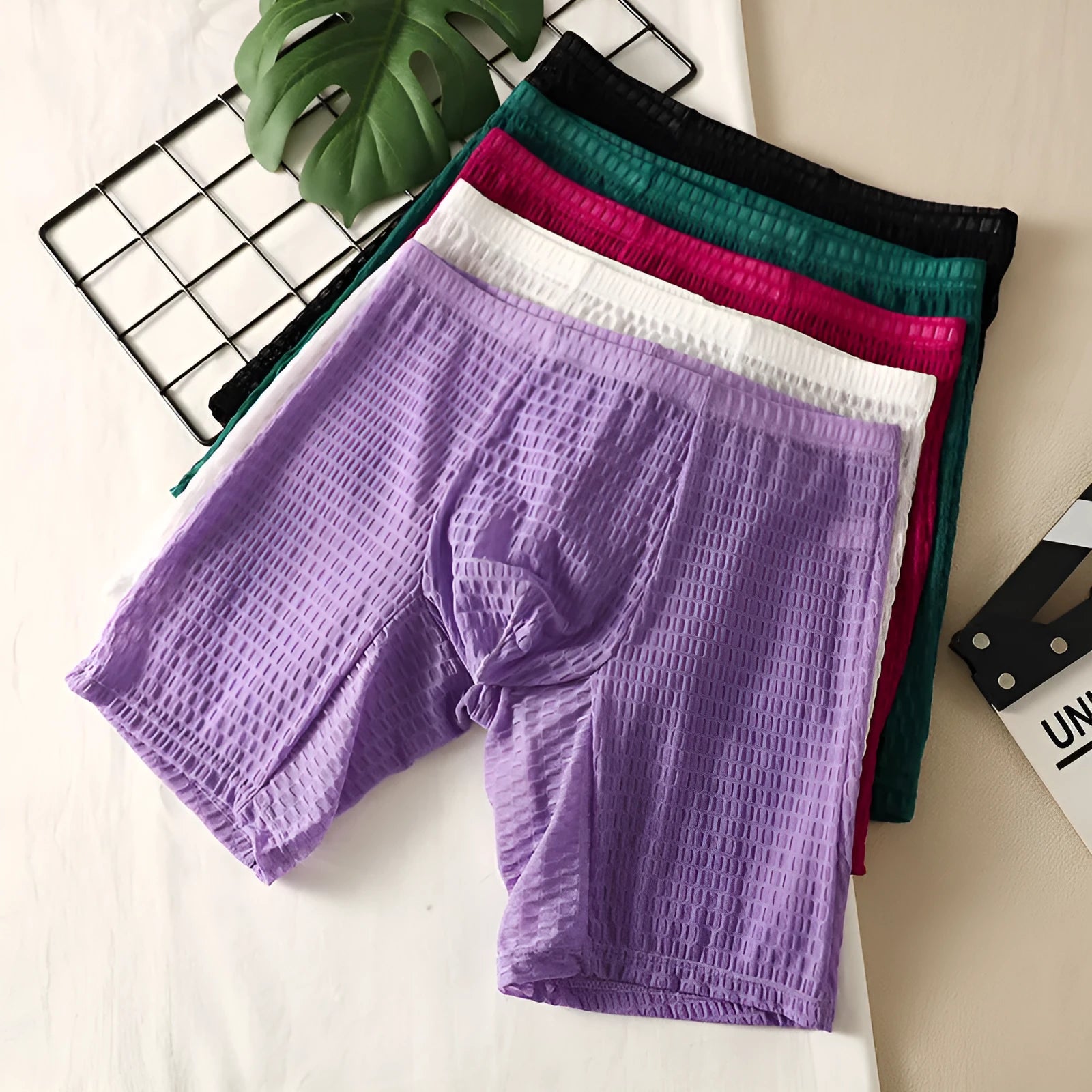 Men's lace shaping boxer briefs in light purple on a white background, showing the hip-lifting design.