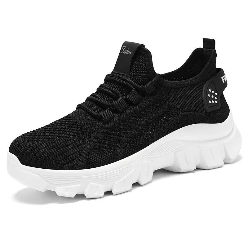 Women's Flyknit sneakers in beige with flat heel, round toe, and lace-up front, showing breathable upper and PVC sole