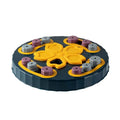 Blue silicone dog slow feeder mat with puzzle grooves and a suction base on a kitchen floor.