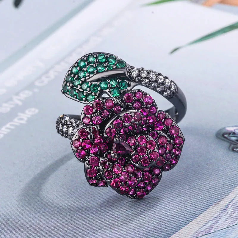 Geometric flower ring with black gold plating and red corundum stone