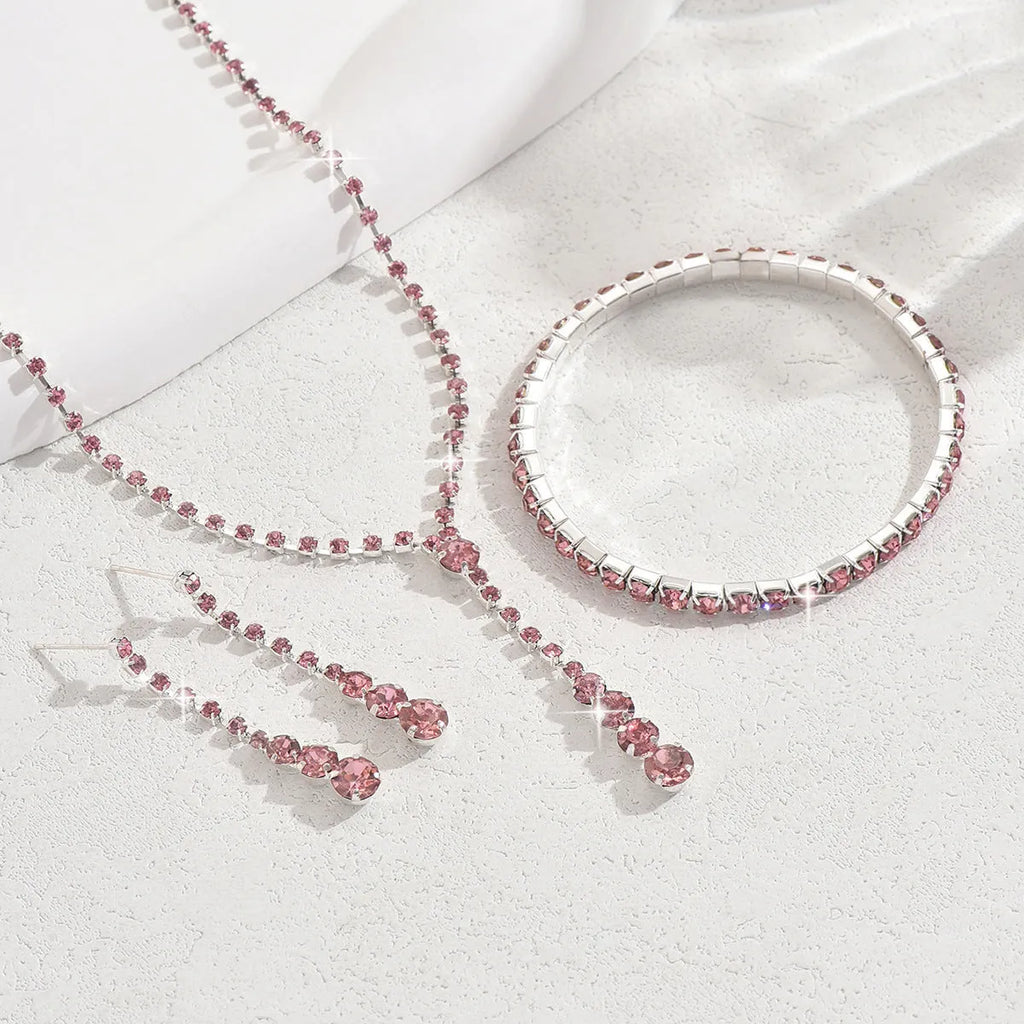 Women's rhinestone wedding jewellery set with heart pendants and tassel details in silver, rose gold, black, or pink