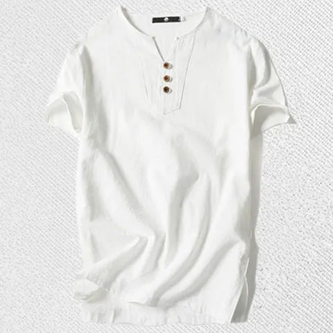 Man wearing a loose apricot coloured cotton linen blend t-shirt, showing the relaxed short sleeve pullover style.
