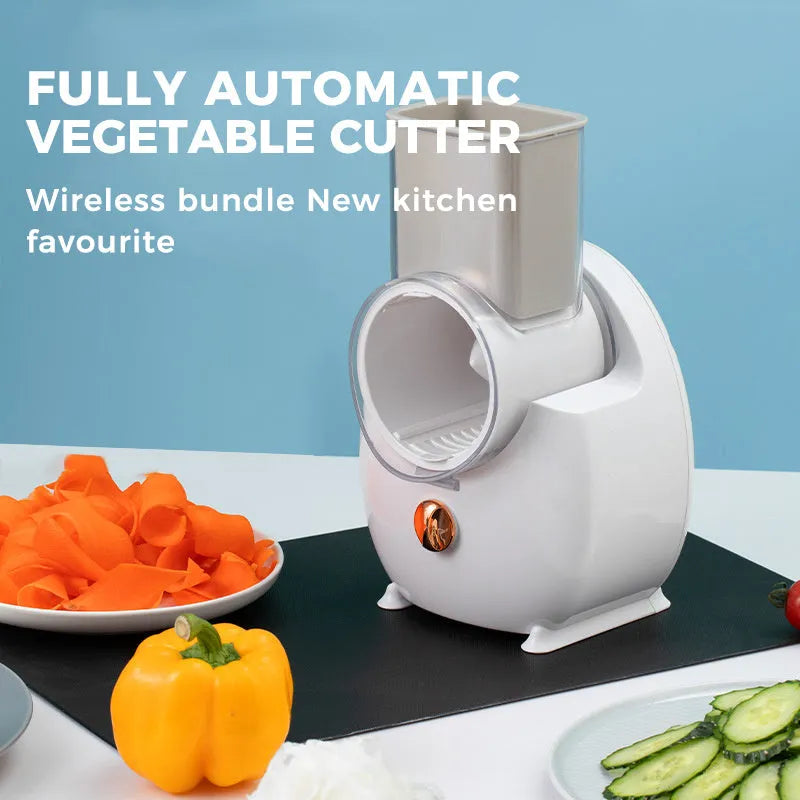 White electric vegetable slicer with interchangeable blades and suction base on a kitchen counter