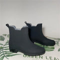 Pair of short rain boots in pink, milky white, or black with non-slip sole and mid-calf length