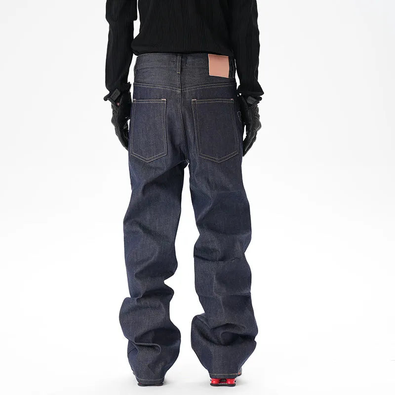 A pair of dark blue loose straight-leg men's jeans on a plain background.