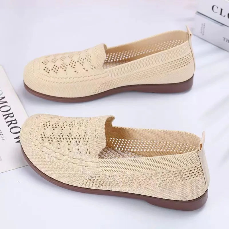 Beige low-top mesh tennis shoes for women with wide feet, showing breathable upper and flat PVC sole.