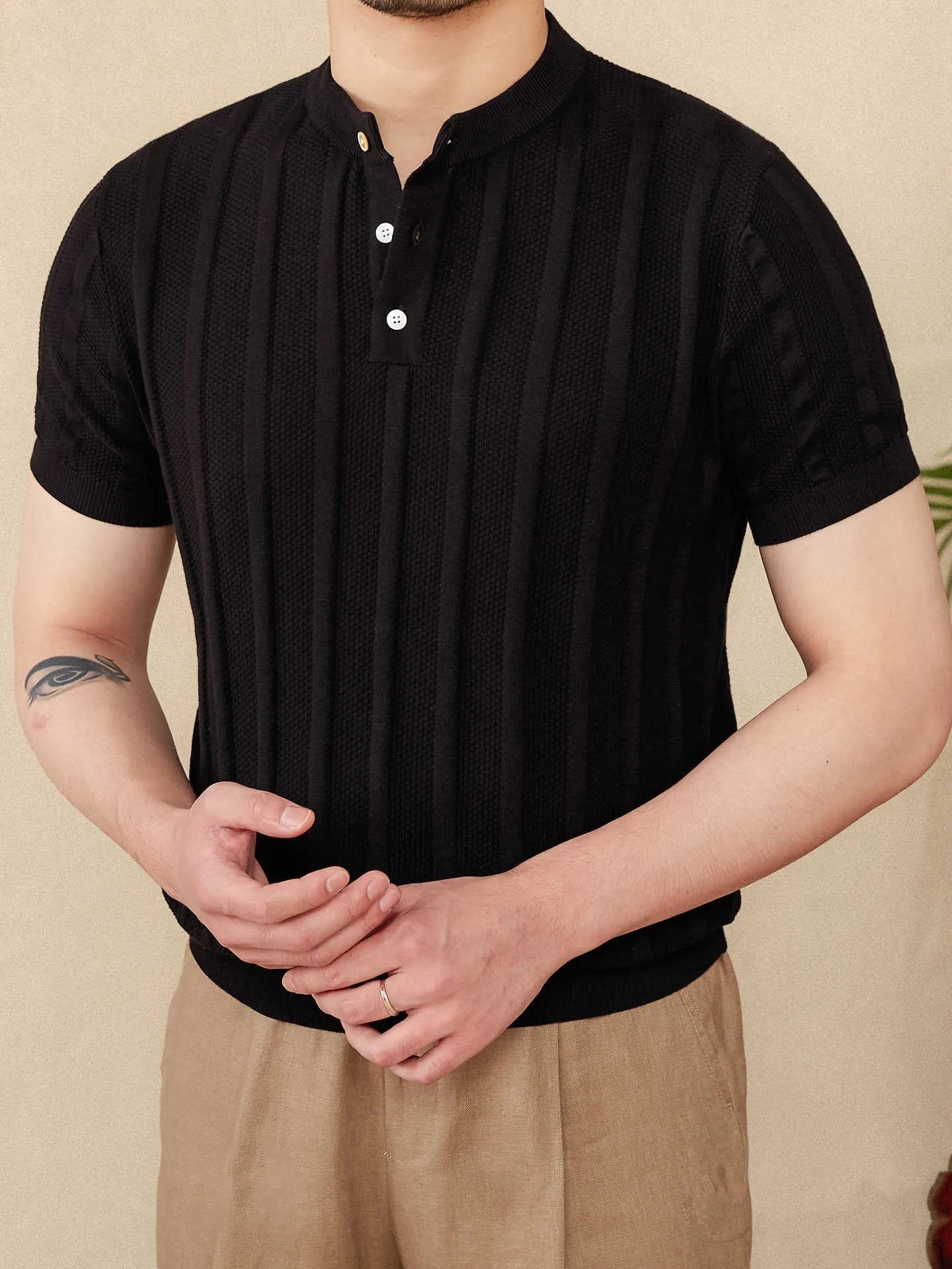 Men's beige cotton T-shirt with henry collar and subtle sunken stripe pattern on the front.