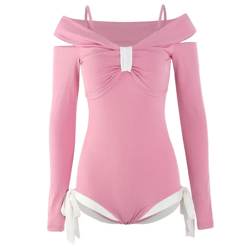 Women's long sleeve one-piece swimsuit in black or pink polyester.