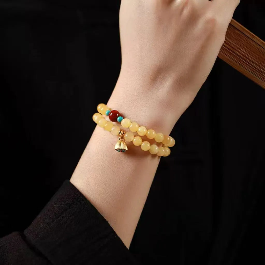 Hand-woven yellow topaz double ring bracelet with lotus seedpod beads for women.
