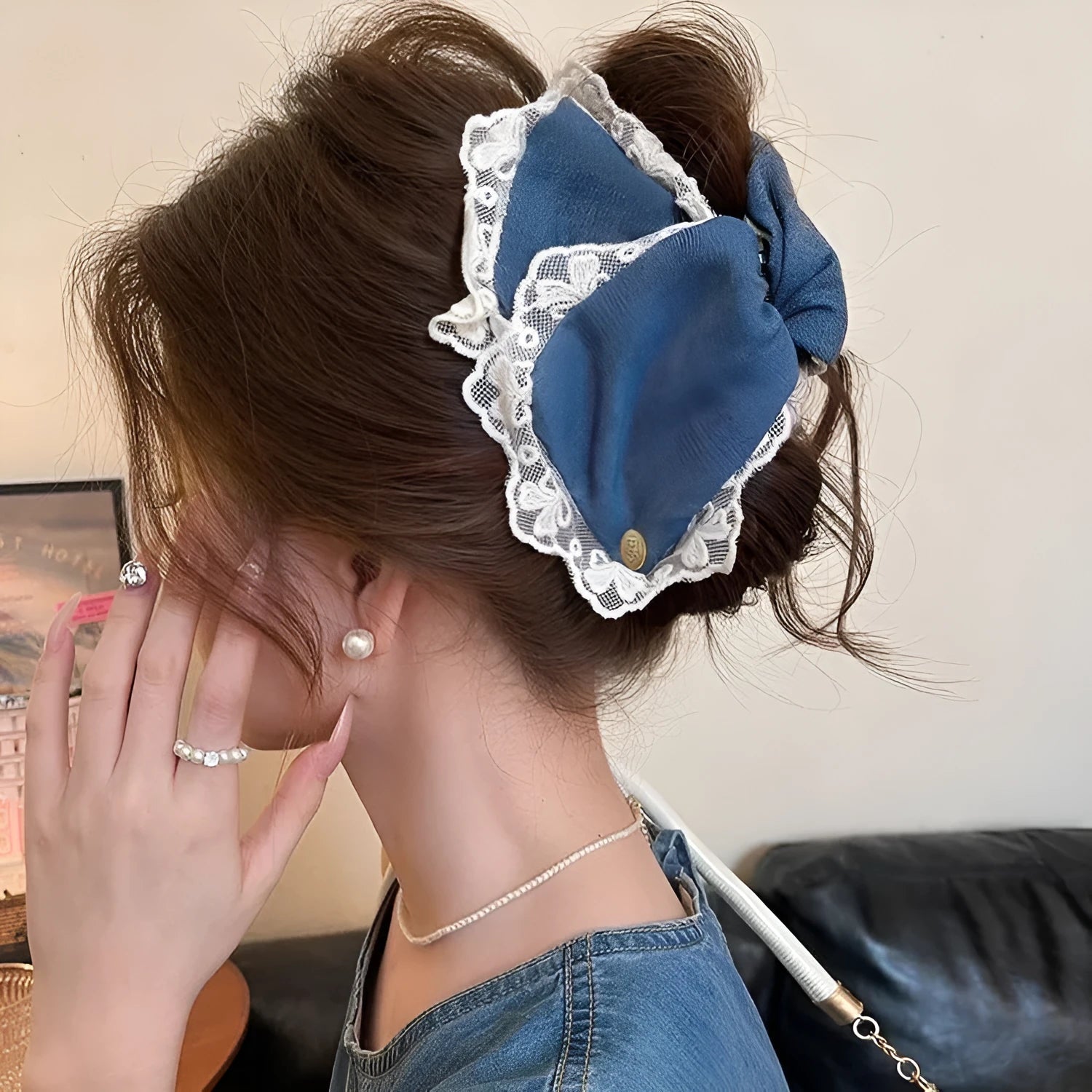 Handmade women's plastic hairpin with denim bow and triangular grip.