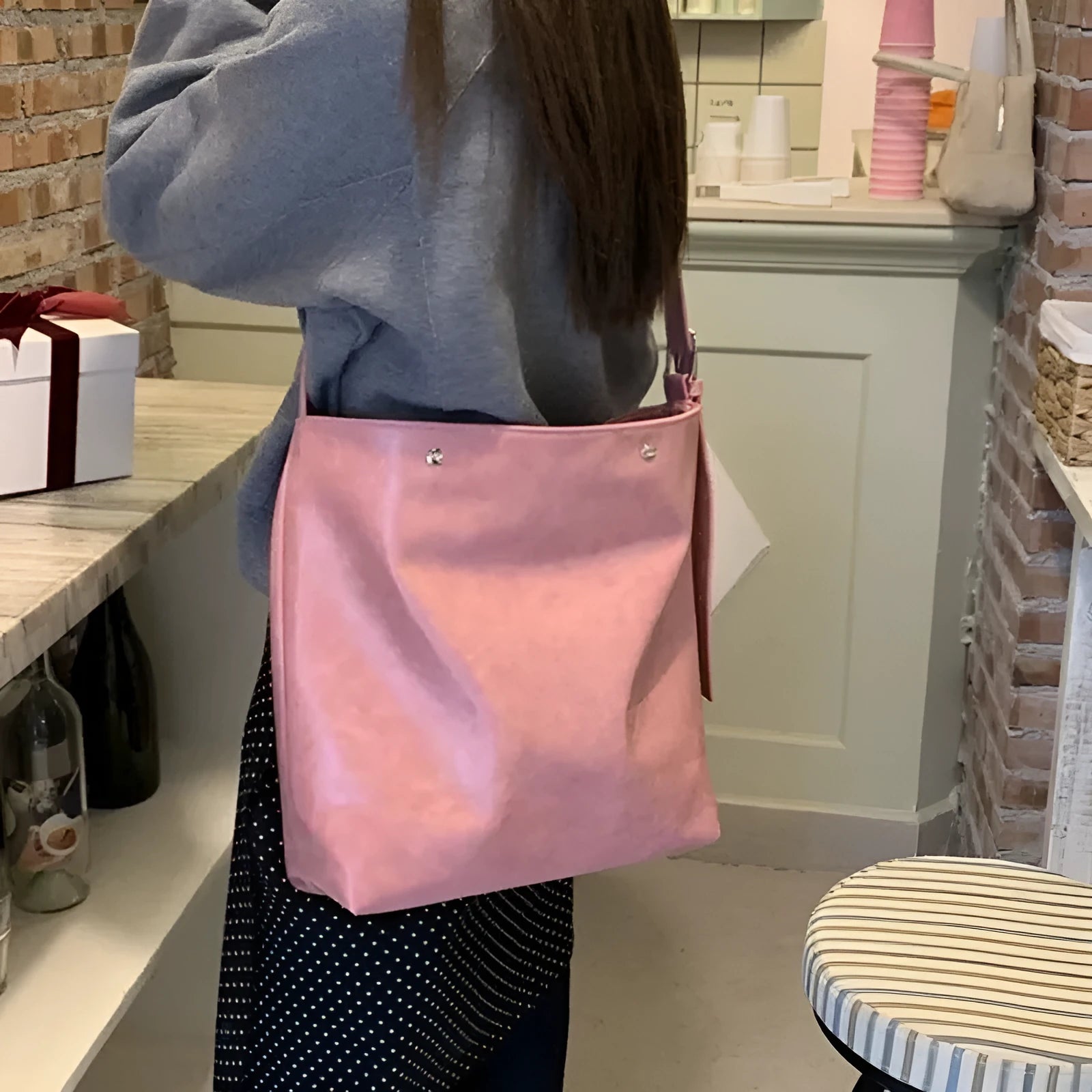 Pink corduroy one-shoulder commuter bag showing size and texture