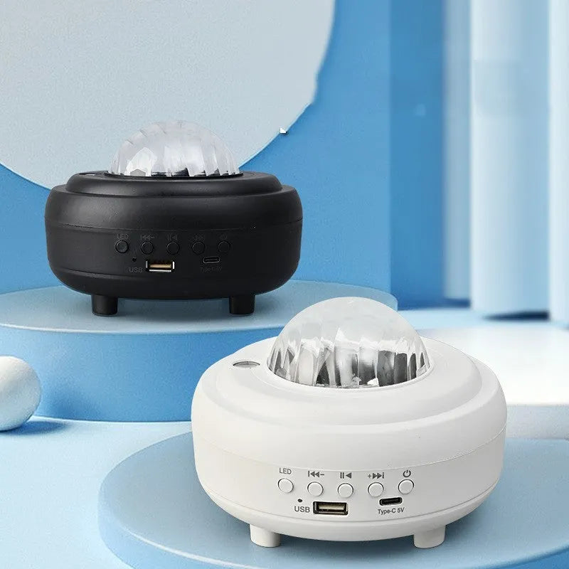 White Galaxy Star Projector on bedside table projecting blue star patterns on wall