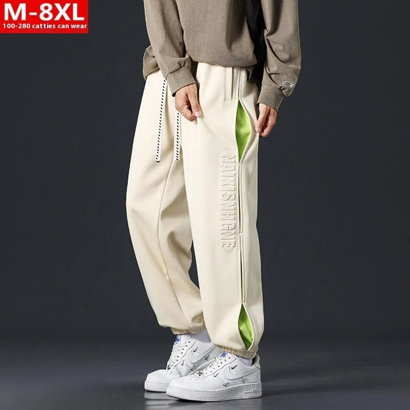 Men's ankle banded trousers in micro-elastic cotton with collage stitching, showing skinny leg and mid-waist fit.