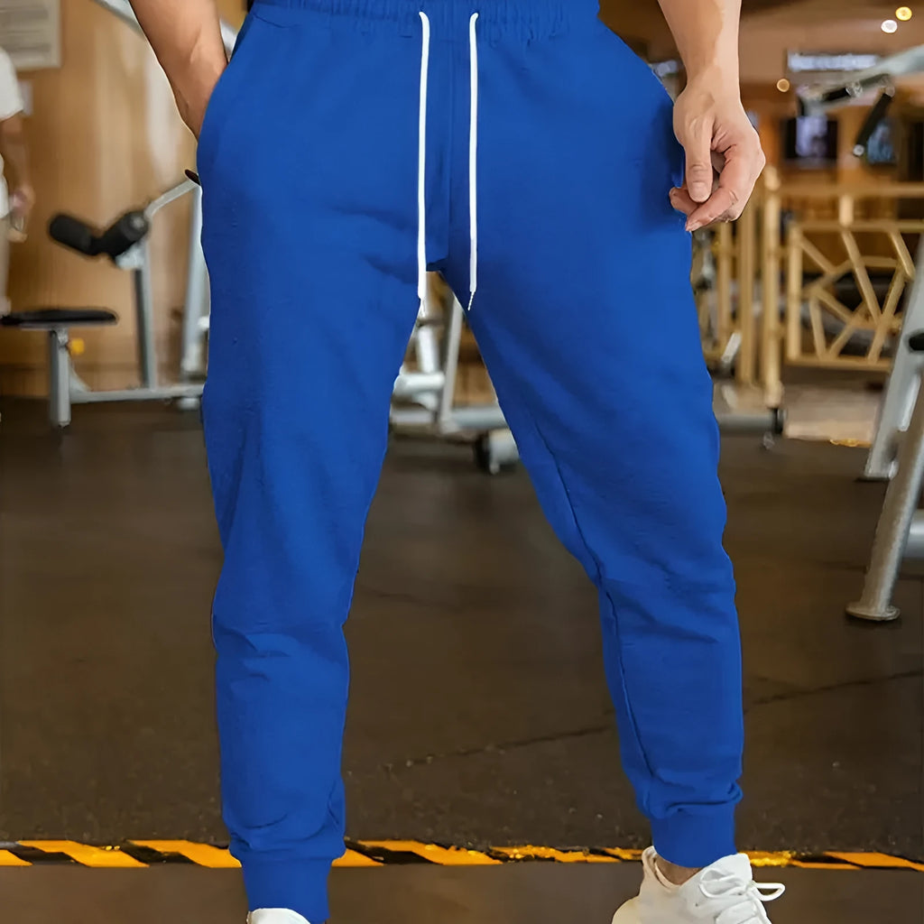 Men's beige loose-fit leisure trousers with an elastic drawstring waist and a thin 3D pattern fabric.