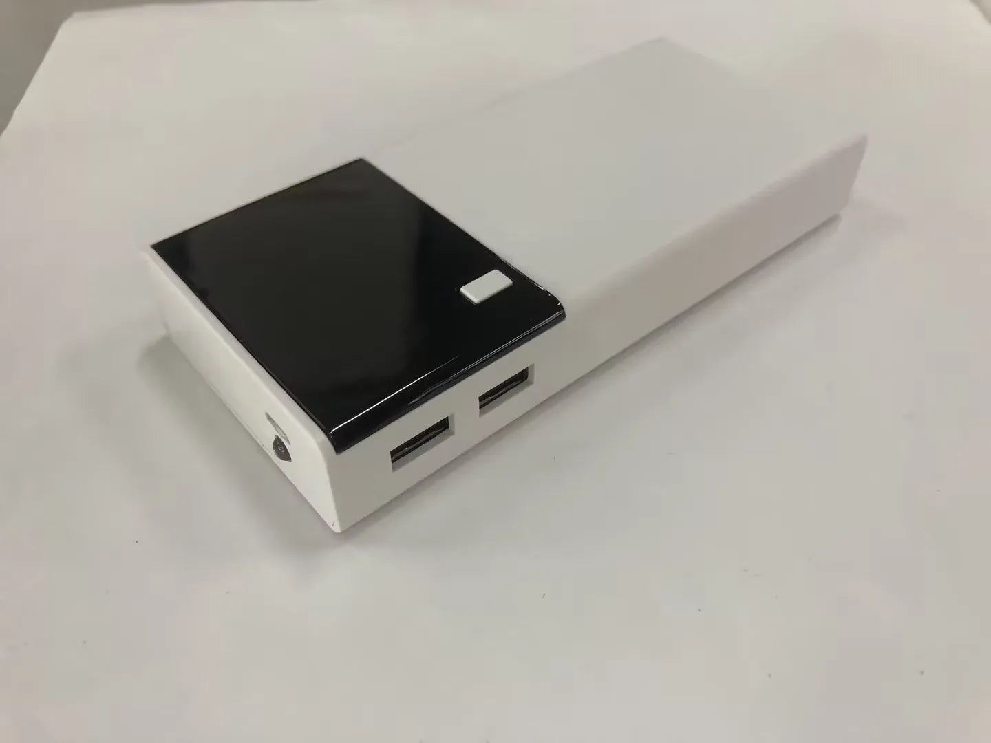 Black Rice 20000mAh portable power bank with plastic casing and included charging cable.
