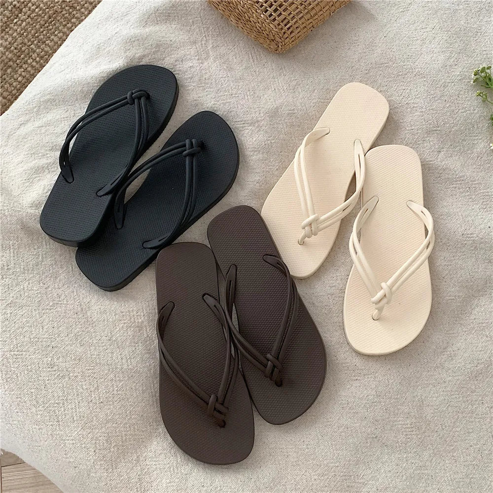 PVC women's flip flops in pink with a non-slip sole and toe-covering strap.