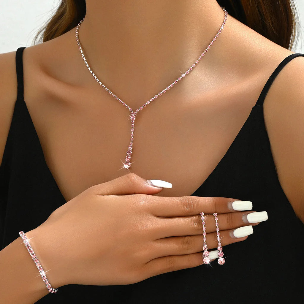 Women's rhinestone wedding jewellery set with heart pendants and tassel details in silver, rose gold, black, or pink