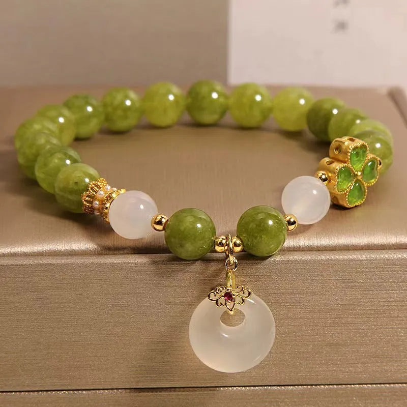 Women's green tourmaline four-leaf clover bracelet with silver electroplated finish and safety buckle clasp.