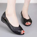 Women's black casual peep toe sandals with an ankle buckle and rubber sole, showing fish mouth toe shape.