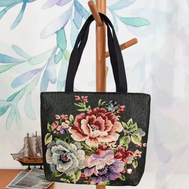 Gold wire embroidered canvas handbag showing bunny design, with polyester lining and top handles.