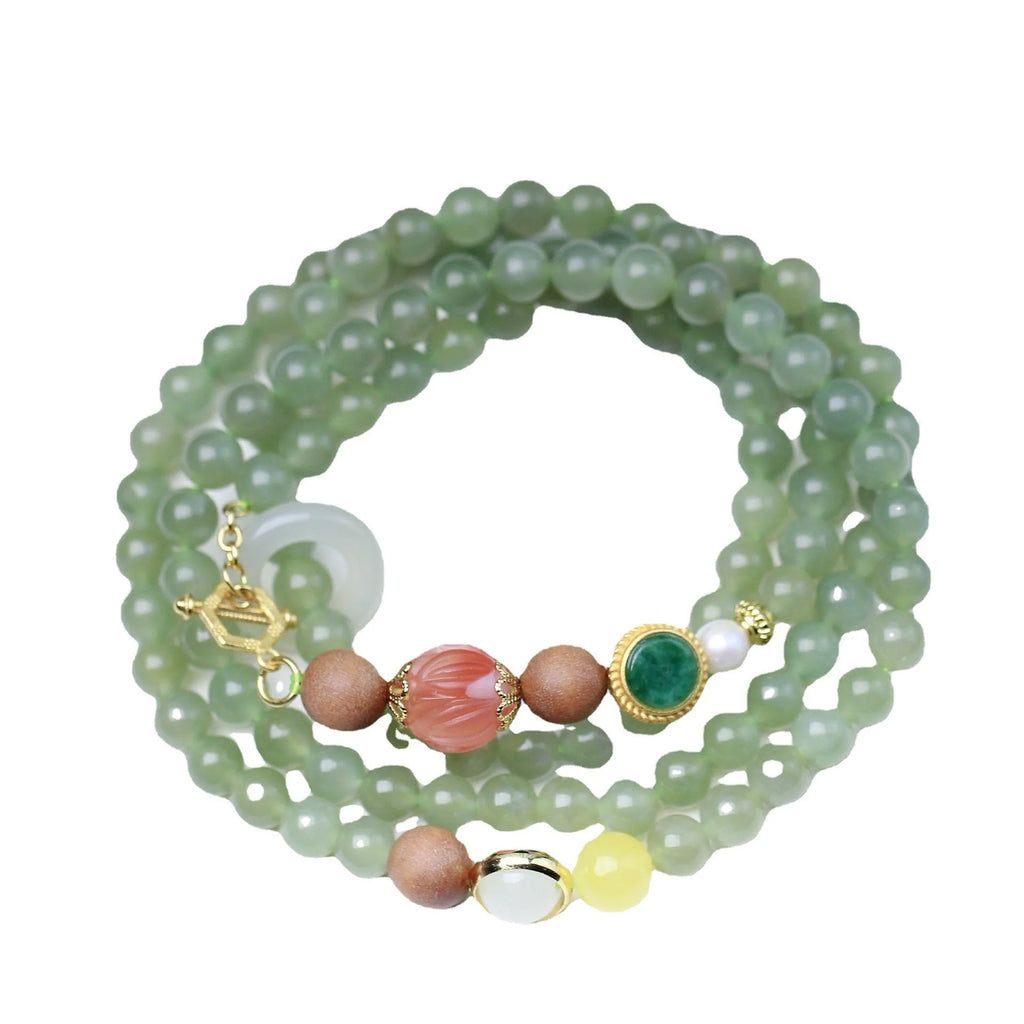 Hetian jade and red lotus bead necklace with matching bracelet on white sandalwood and beeswax.
