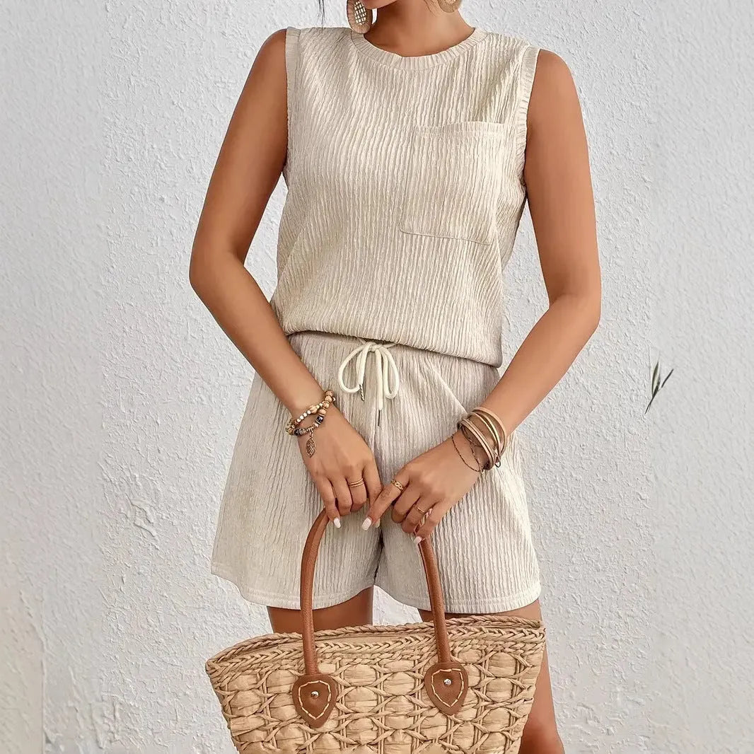 Solid colour sleeveless round neck vest and shorts set in apricot or orange, made from 100% polyester with S to XXL sizing options.