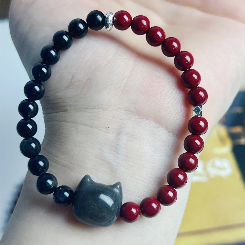 Handmade obsidian colour cat bracelet with carved black cat charm and colourful beads on black elastic cord