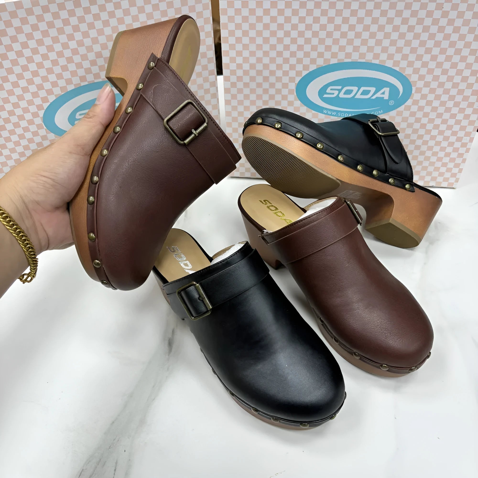 Black retro chunky heel slippers with closed toe and silver rivet details on a rounded toe.