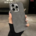 Frosted solid colour suede iPhone case in dark green, shown on an iPhone.