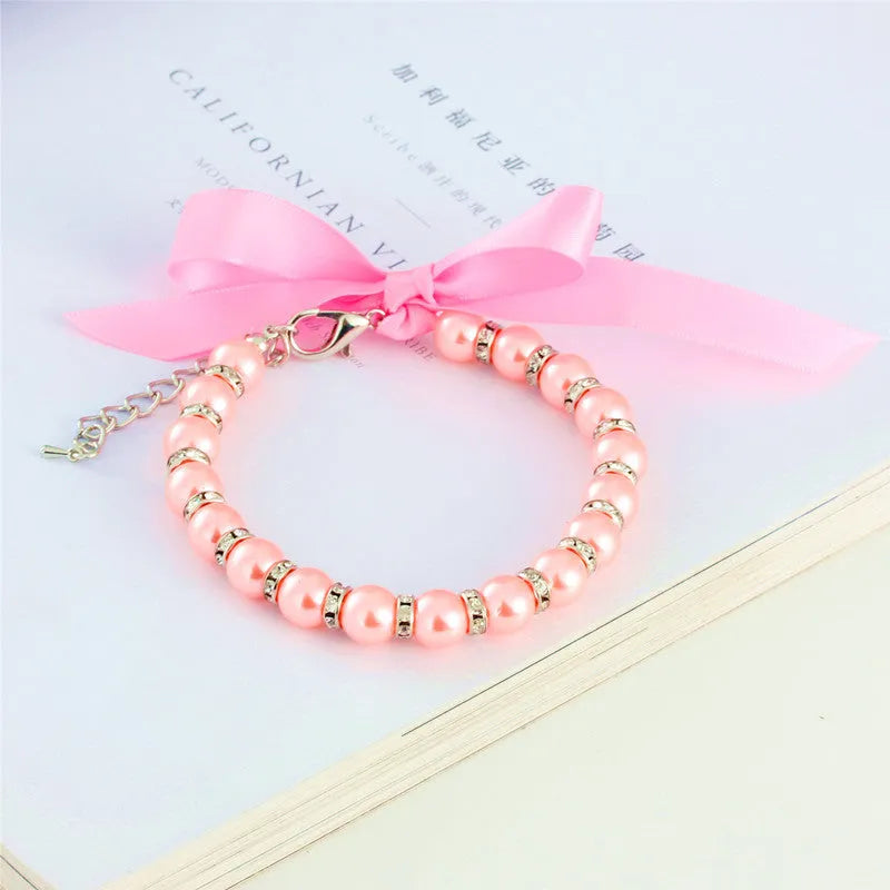 Diamond dog pearls necklace with adjustable clasp, imitation pearls, and rhinestones on soft ribbon for small pets