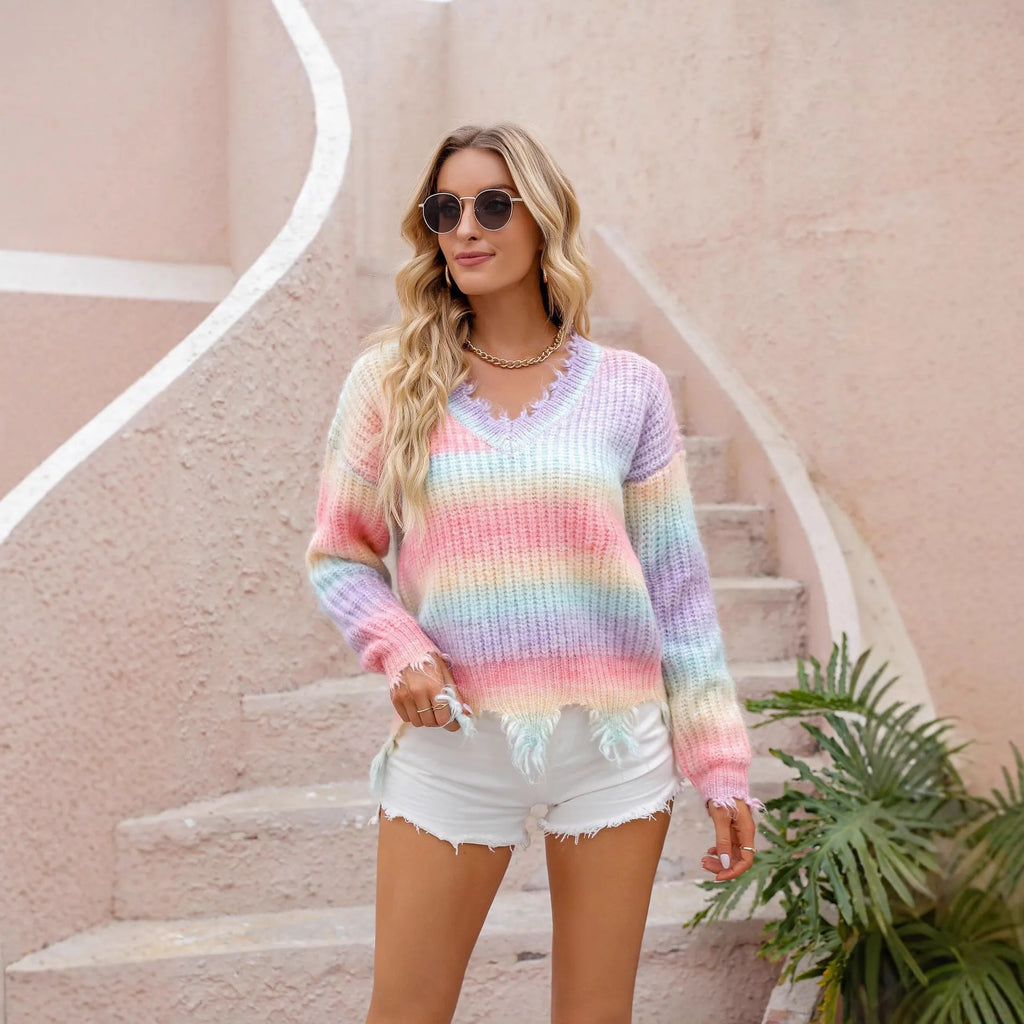 Pink knitted pullover sweater with a gradient rainbow pattern and loose, relaxed fit.