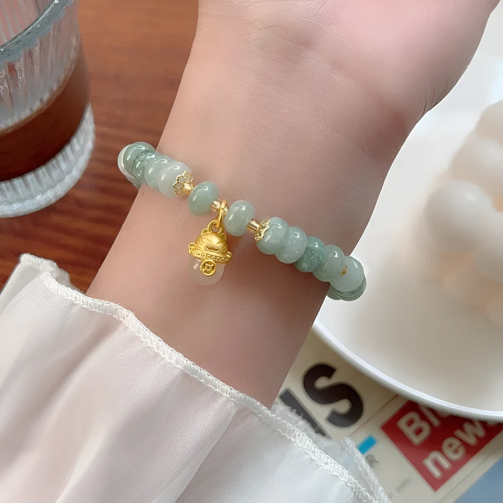 Women's strawberry quartz lucky cat bracelet with animal zodiac charm and retro styling