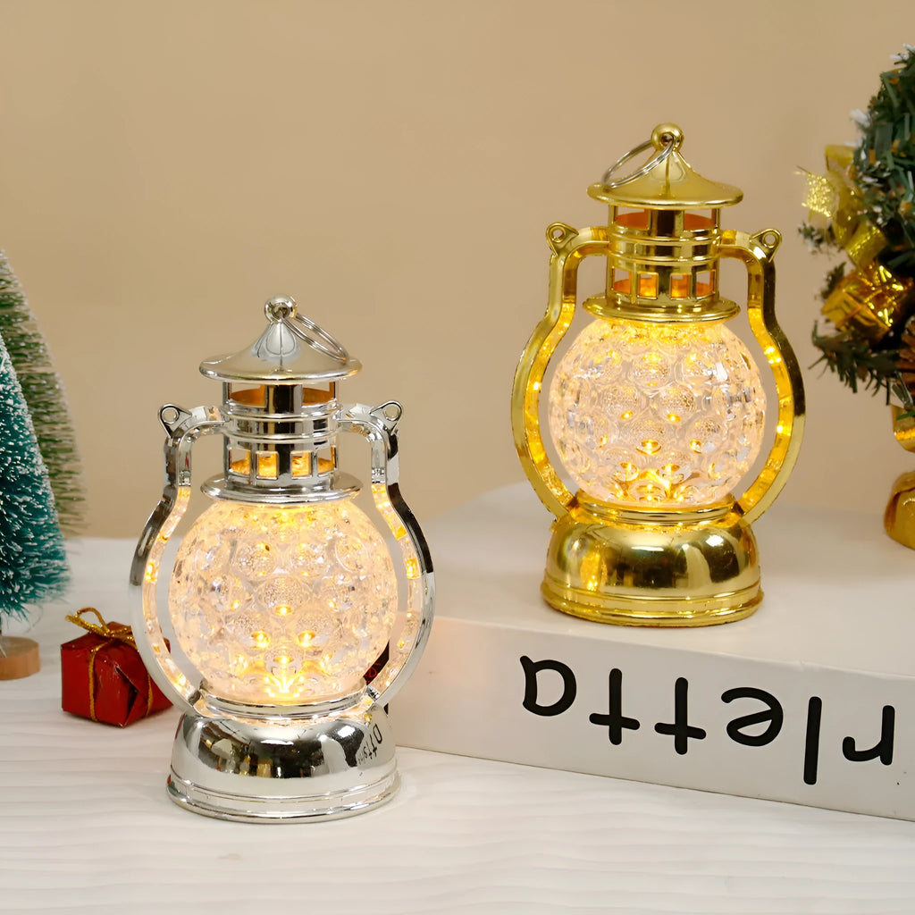 Creative retro-style small oil lamp LED night light in gold or silver finish on a table.