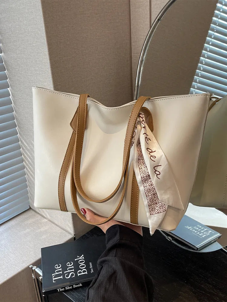 Soft tote bag with crossbody strap showing internal zipper compartment and khaki colour option