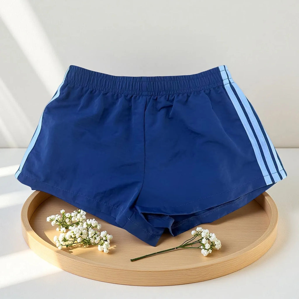 Navy blue men's high-waist nylon sports shorts on a white background
