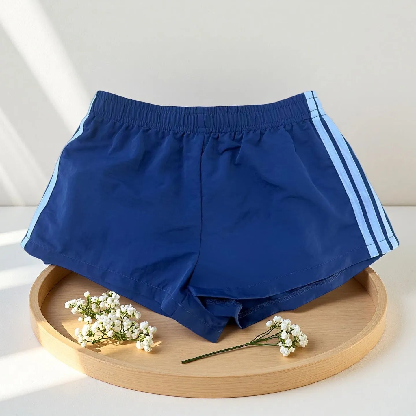 Navy blue men's high-waist nylon sports shorts on a white background