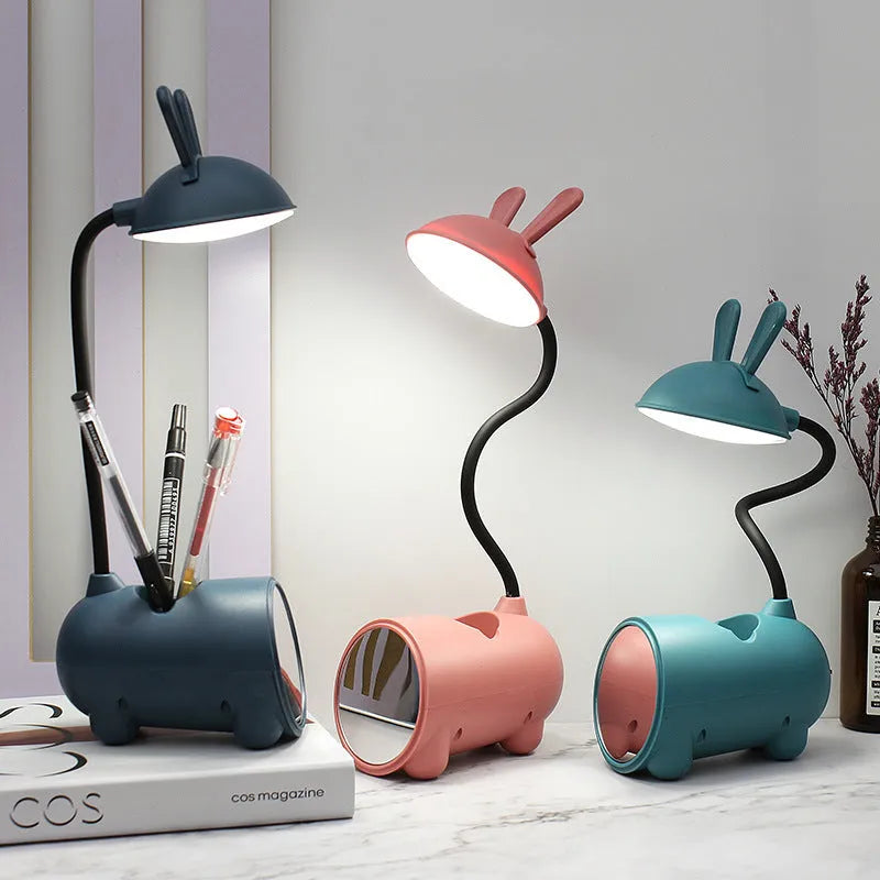 Green cartoon desktop lamp with pen container, USB cable, and modern simple design on wooden desk
