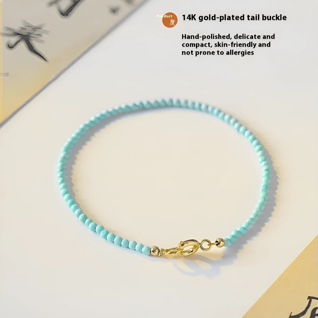 Natural 2mm raw ore turquoise bracelet on wrist, showing geometric beads and adjustable extension chain.