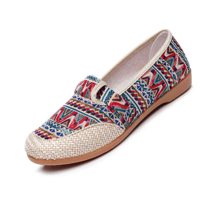 Women's ethnic style cloth shoes with flat heel, colour stitching, and a shallow mouth design.