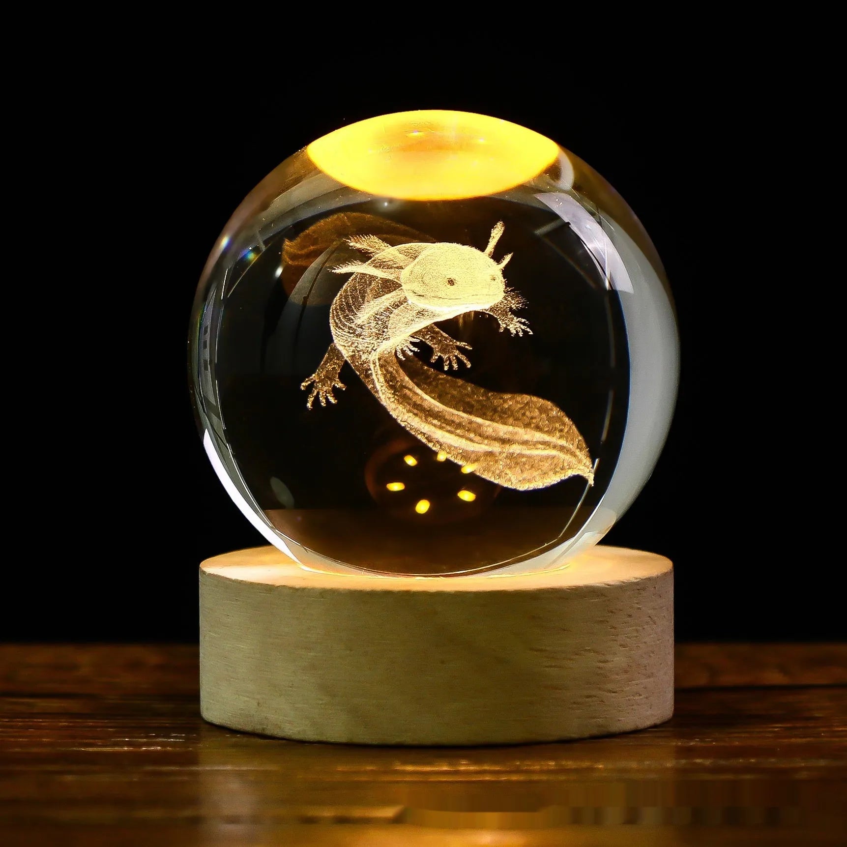 3D crystal ball night light projecting starry sky and planets from its 6cm sphere on a solid wood base.