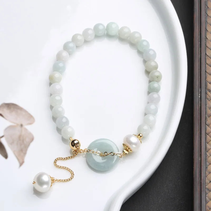 Natural emerald peace buckle pearl bracelet showing geometric jade design with round pendant