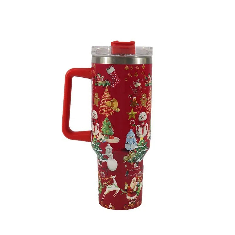 A large stainless steel travel mug with a handle, straw, and Christmas pattern, shown next to its leak-proof lid.