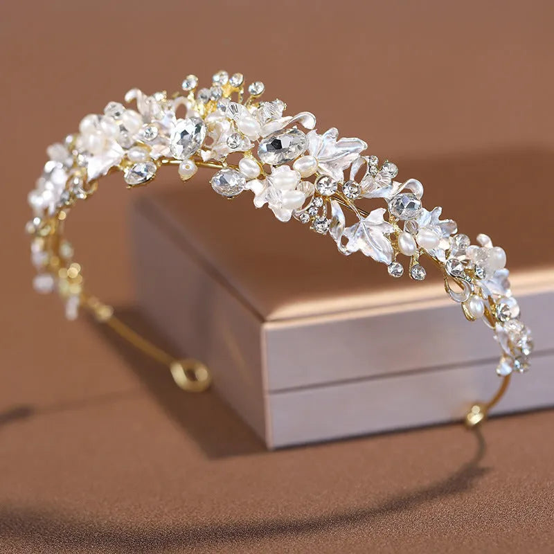 Gold and silver alloy pearl crown headdress hair accessory for women on a white background.