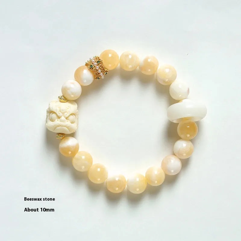 Hand-woven bracelet with round grey agate and mellite beads on a white background.