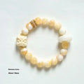 Hand-woven bracelet with round grey agate and mellite beads on a white background.