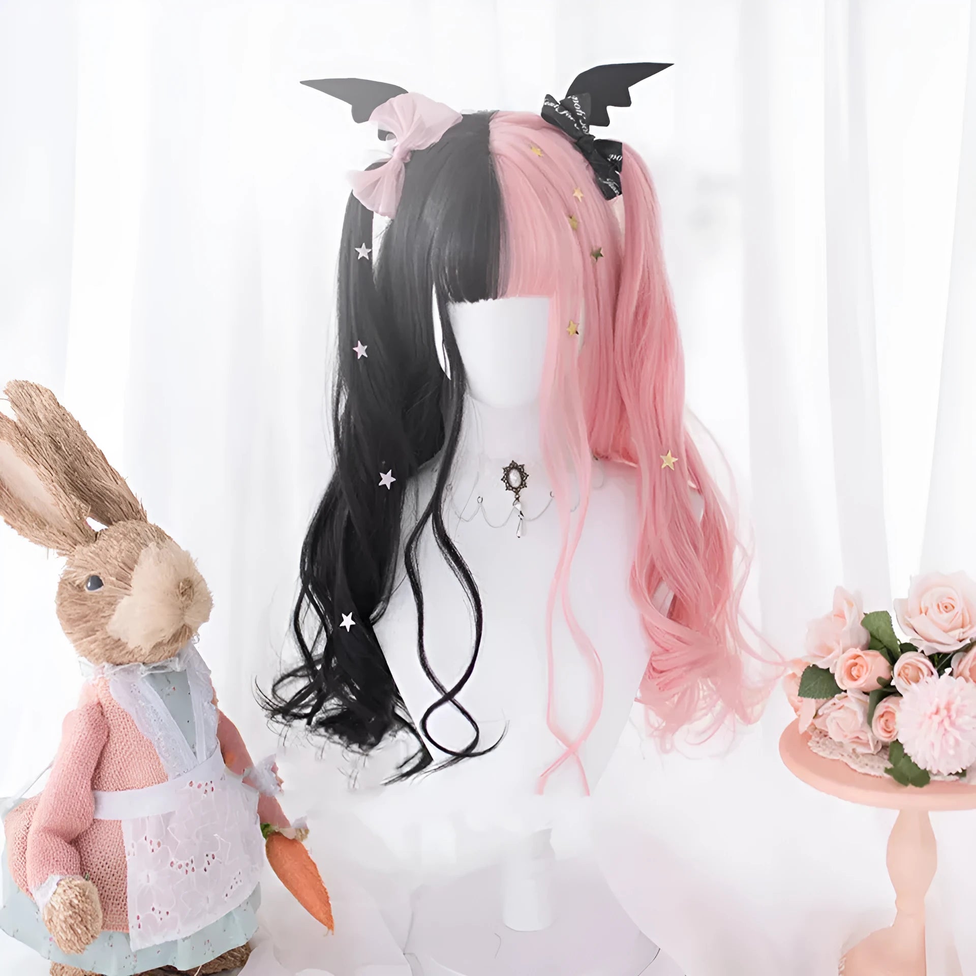 Harajuku Japanese Lolita long curly wig in black and pink colours with bangs on a wig stand.