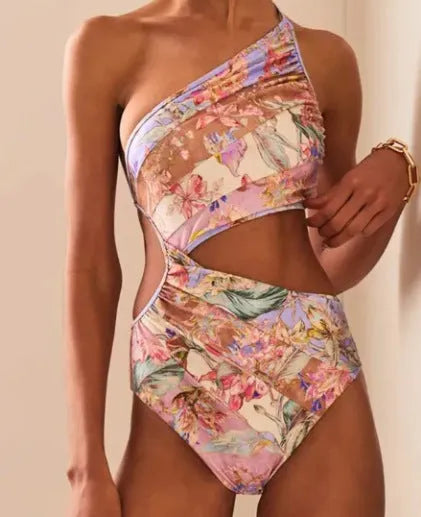 Women's rose gold patterned swimsuit on a hanger.