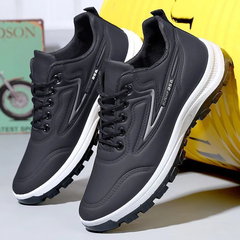 Waterproof casual sports shoes in black-grey colour with flat plastic sole and low-top design